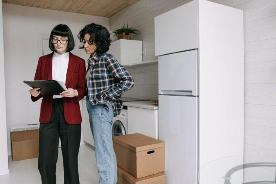a landlord and tenant looking at a clipboard together